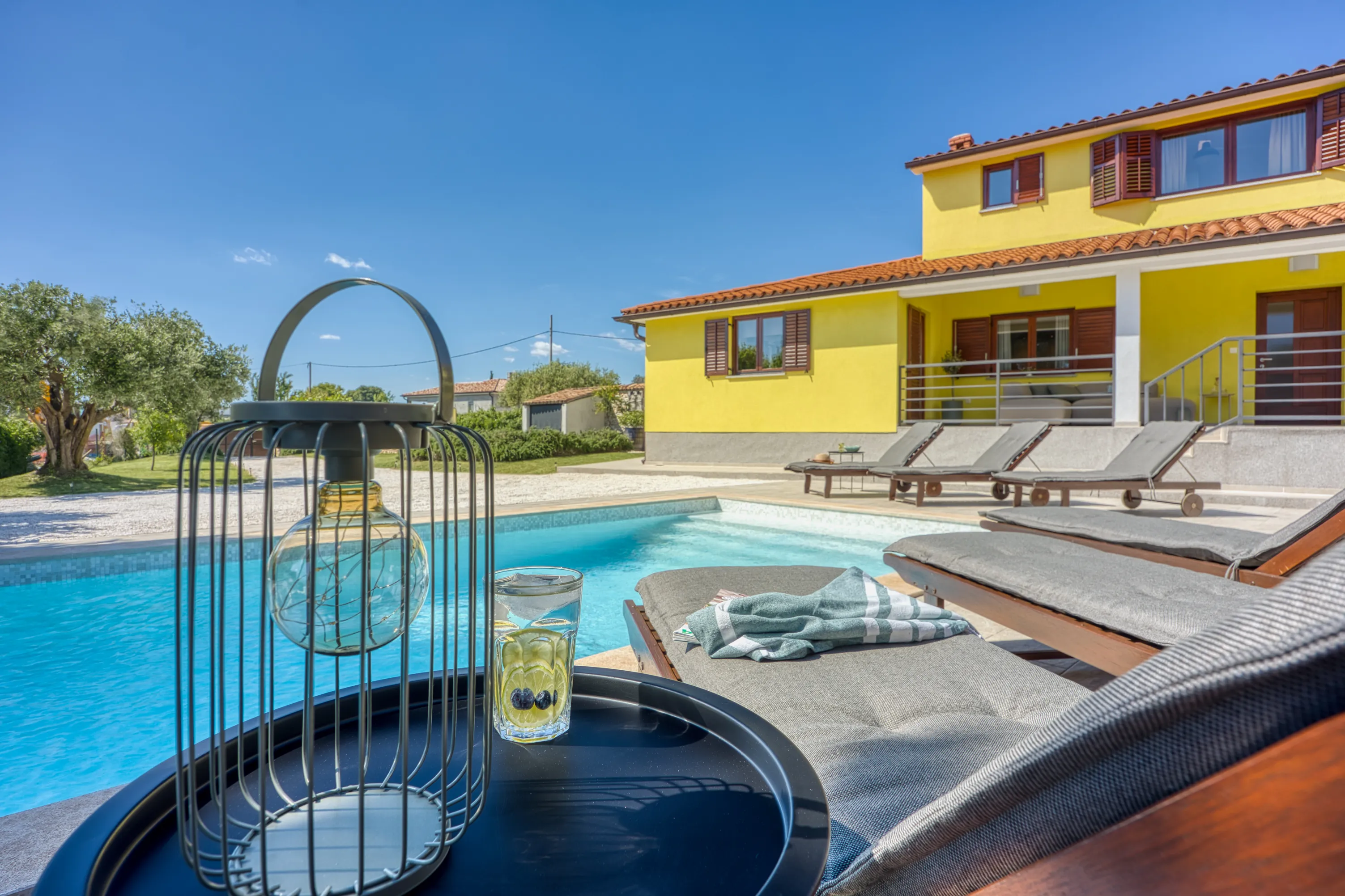 Pool terrace with loungers at Casa Lera